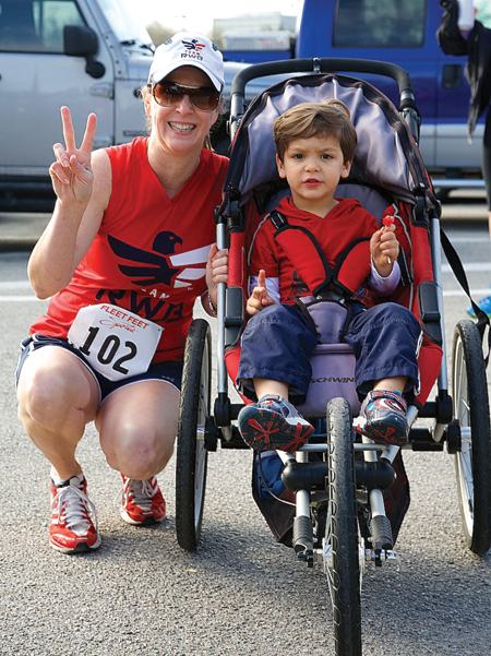 Families ruled the day at the first ever HAR Fun Run. Here is Kay Hyle of RE/MAX Top Realty with her son who did eventually abandon his stroller for the thrill of walking across the Finish Line. Photo courtesy of Ward Arendt. 
