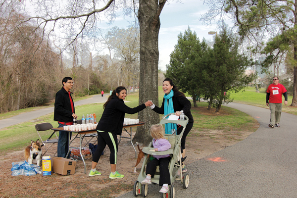 HAR Family Fun Run Event Chair Karishma Asrani hands out water to Fun Run Committee Member Courtney Katz at the water station which is manned by HAR Staff Member Patrick Partida and his dog Chelsea. Around the bend, strolls HAR’s Director of Information Sam Scott. It was a true HAR Family Event on Saturday, February 22.